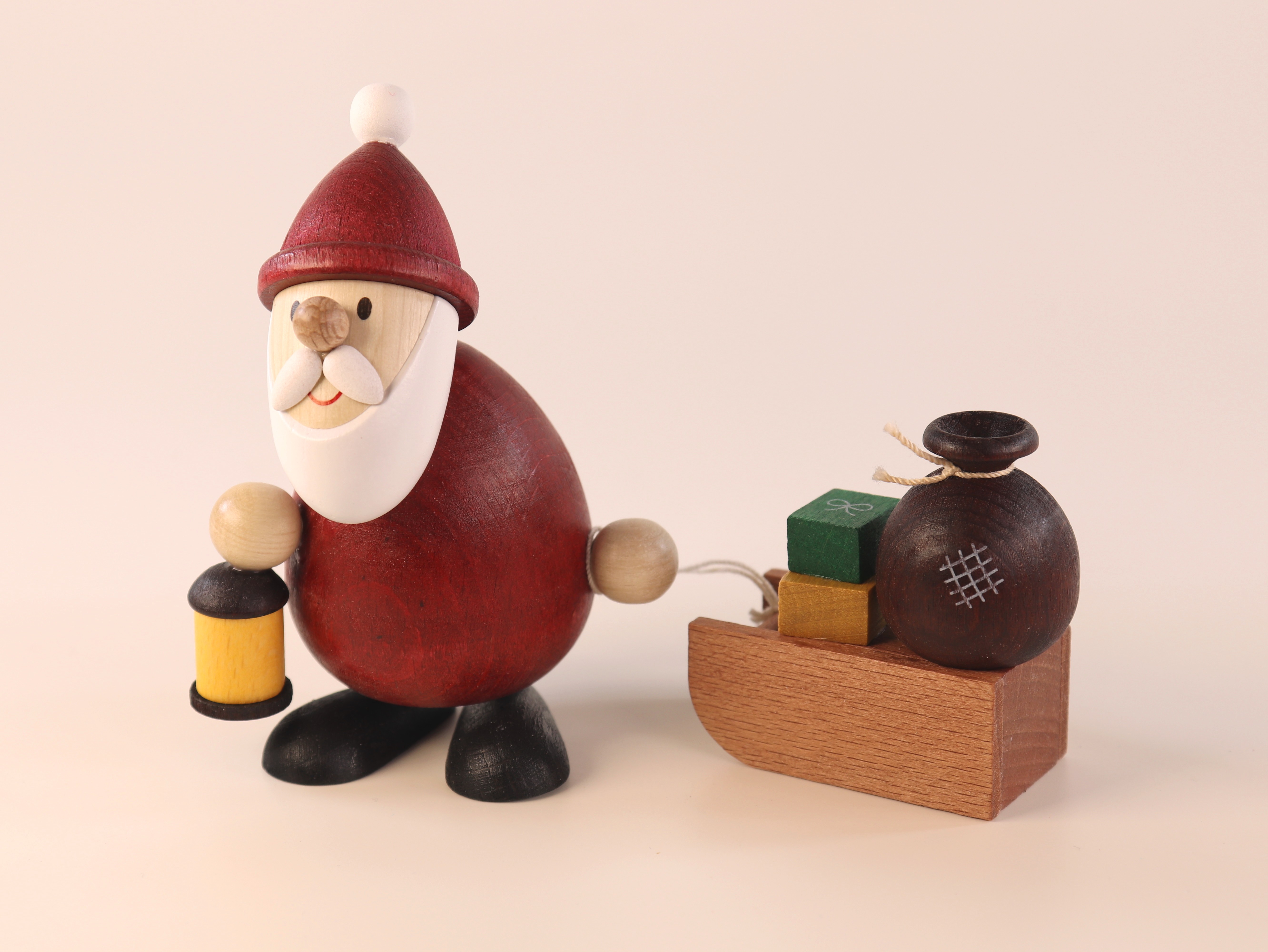 Weihnachtsmann modern mit Laterne und Schlitten mit Sack als Weihnachts-Tisch-Dekoration